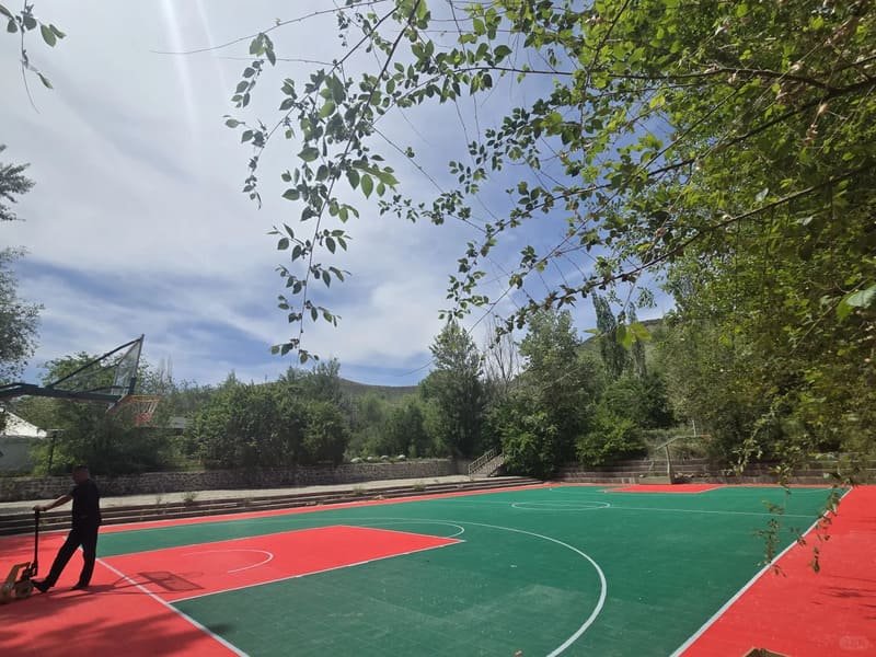 Split image showing modular tiles vs cracked asphalt